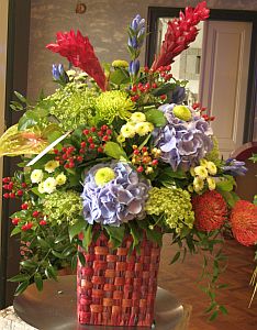 Mother's day colorful arrangement made of blue hortensia, red alpinia, anthurium